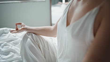 yogi body meditating asana in morning closeup. serene girl hands practicing yoga