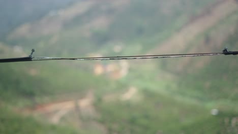broken cable over a blurry mountain landscape