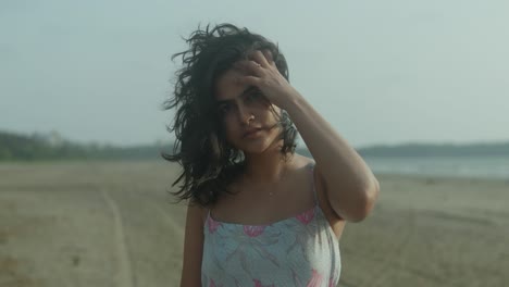 Indian-woman-with-long-hair-is-standing-on-a-beach-capturing-a-tourist-spot-and-a-healthy-lifestyle