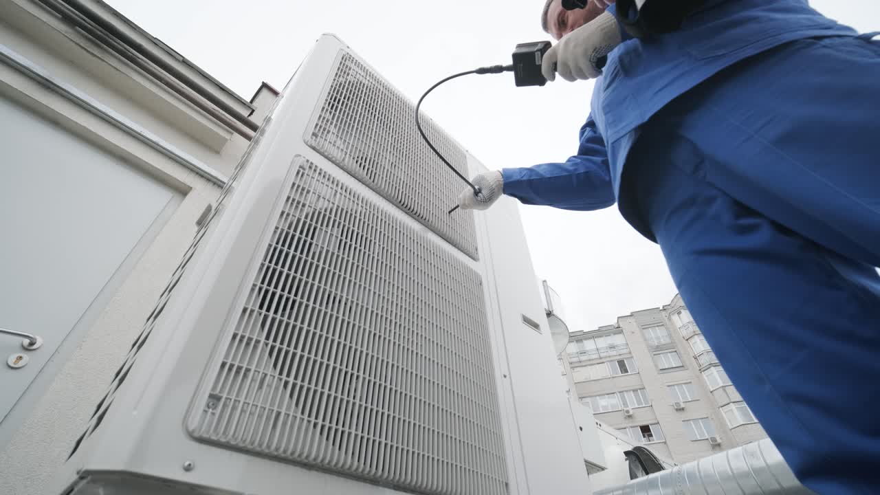 The technician uses a digital camera to check the clogging of the heat exchanger
