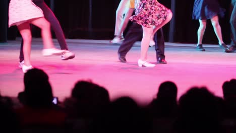 silhouettes of people sitting at a theater watching a group of dancer dancing rock and roll.mp4