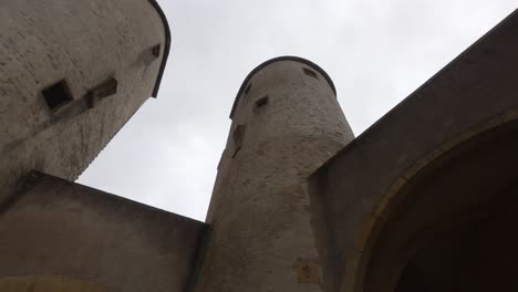 towers of the german's gate castle in alsace–lorraine reach for the sky on a cloudy day