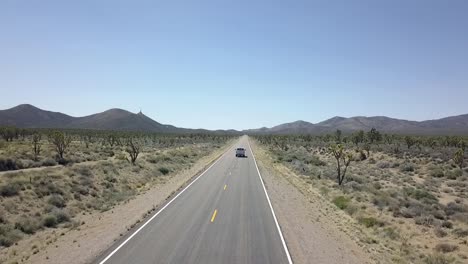 ottima vista aerea volo inseguimento volo drone riprese di un camioncino bianco su una strada vuota con strisce gialle nel deserto coachella valley stati uniti 2018