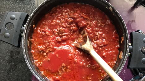 preparing tomato sauce with meat for the paste.