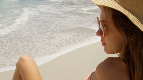 side view of caucasian woman relaxing on the beach 4k