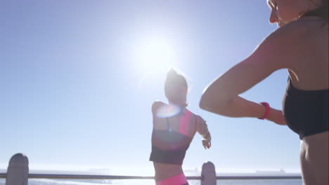 Two-athletic-friends-stretching-on-promenade-before-run