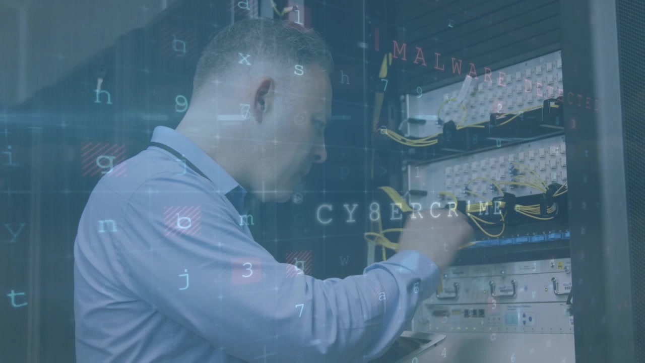 A technician is using a laptop to analyse a server in high quality format