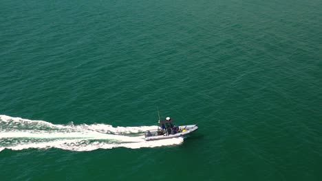 motorboat cruising mission bay in san diego, california - aerial drone shot