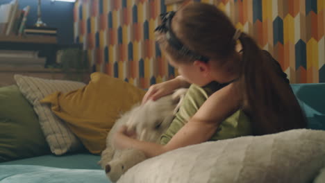 dog and child playing on a sofa