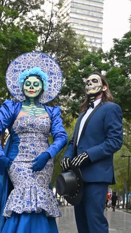 day of the dead, couple in vibrant costumes in the alameda central park during the day of the dead celebrations