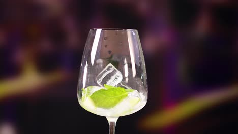 a sequence of pouring a mojito cocktail into a glass with ice and lime, set against a vibrant background