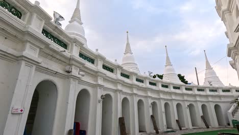 a tranquil exploration of wat prayurawongsawas worawihan in bangkok, showcasing its stunning white architecture under soft daylight