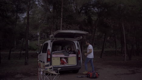 van life traveller and his own white modern camping car parked in national park forest enjoying pure nature wilderness