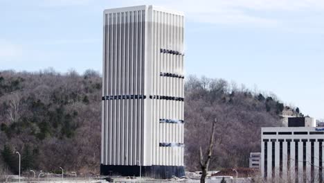 demolition of tall building resulting large plumes of demolition dust and debris in frankfort, kentucky