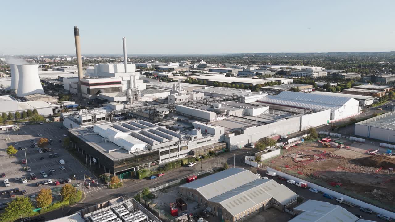 Dynamic drone approach of Mars Wrigley's industrial facility on Slough Trading Estate, Berkshire, UK, October 2024