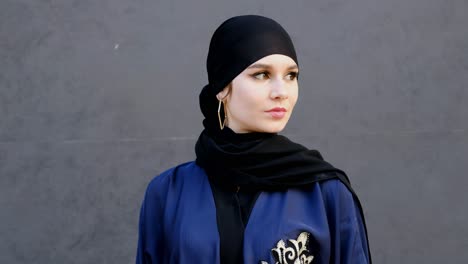 portrait of arabic woman wearing emirati style abaya and hijab shayla headscarf