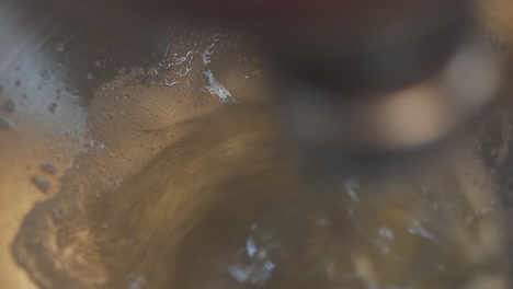 electric mixer spins and shakes sugar with eggs into cream