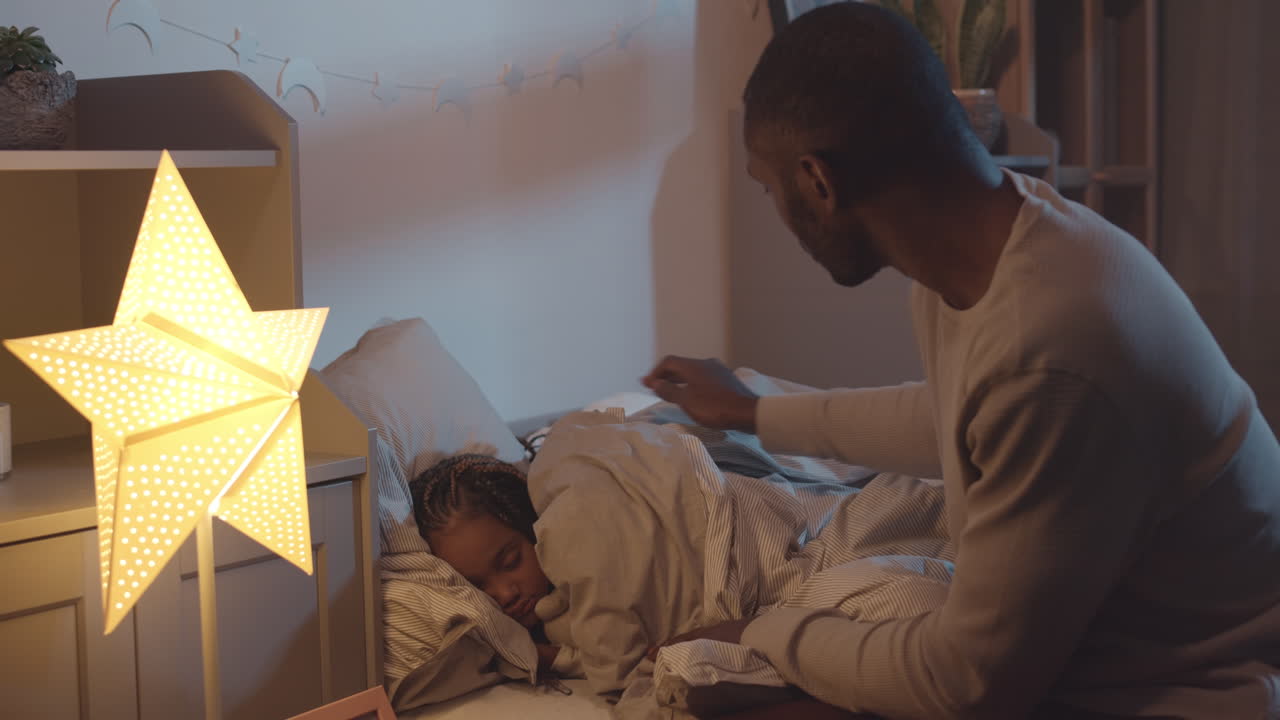 Father Covering Daughters with Blanket