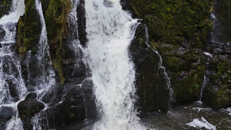 4K-Video-of-small-waterfall-in-forest-with-moss-covered-rocks