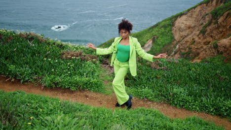 Focused-woman-dancing-expressive-dance-movements-at-gloomy-seashore.-Girl-moving