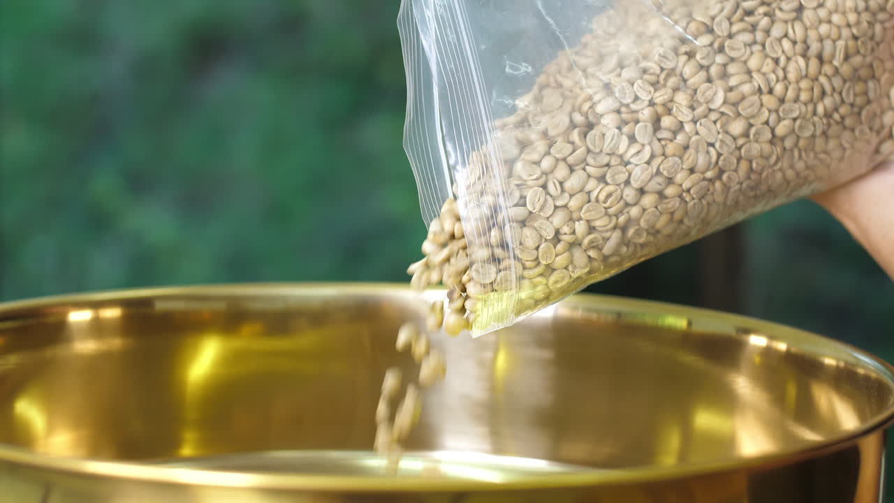 Pouring Coffee Beans Into The Roaster Machine