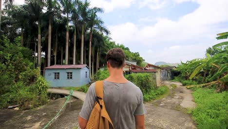 male hiker walking on a trail in hong kong island countryside