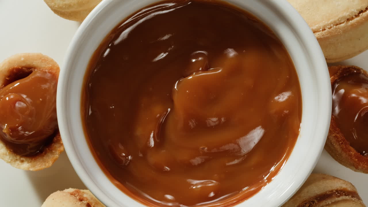 Homemade walnut shaped cookies with boiled condensed milk on grey table, flat lay. High quality 4k footage
