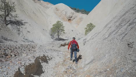 hiker walking within sulphur walls of big rock candy mountain