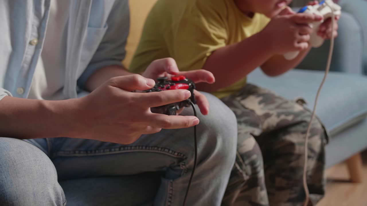 Close Up Of Hand'S Father And Son Using Joystick Play Game