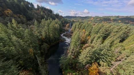 Flying-over-then-diving-down-close-to-a-waterfall-in-Washington-State