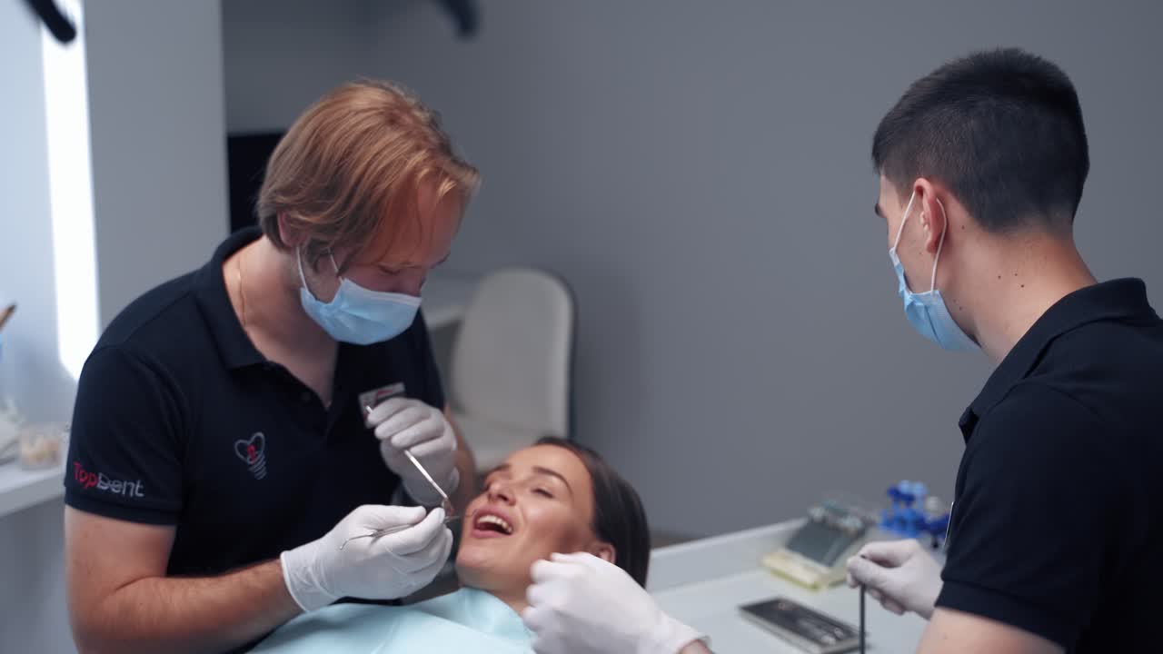 Stomatology treatment in dentistry. Beautiful young woman having dental treatment at dentist office