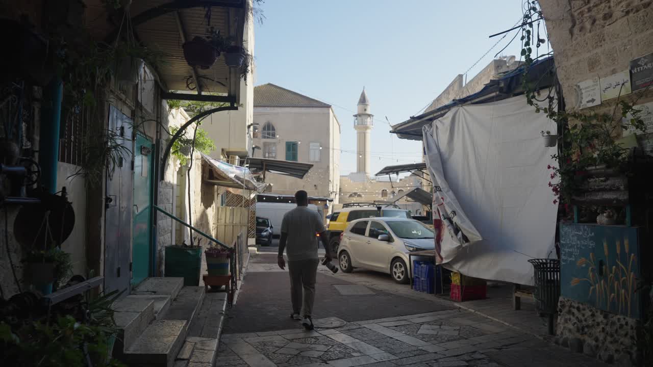 POV: Man walks from dark alley in Nazareth old town