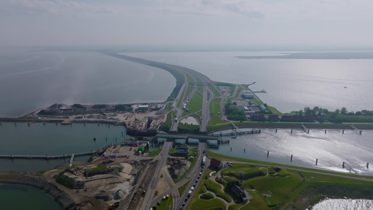 Aerial semi orbit revealing the Afsluitdijk dam and the long highway connecting Friesland and North Holland over the sea