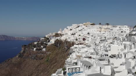 long sweeping aerial of clifftop homes stunning view of aegean sea