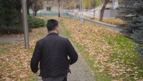 the man with helpless and psychological problems is walking outdoors.