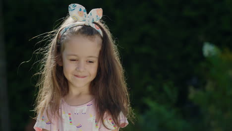 portrait of a cute little girl with a bow in her hair