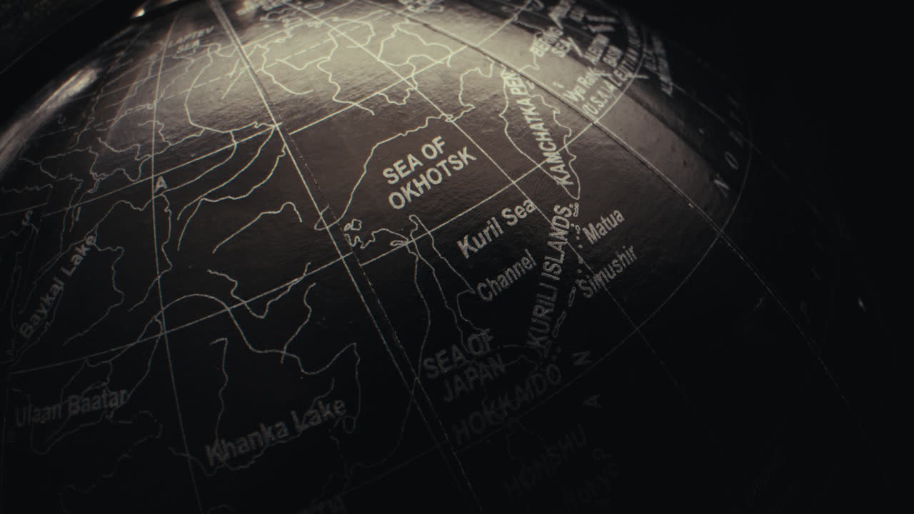 Close-up of a black globe showing details of Asia and Mongolia