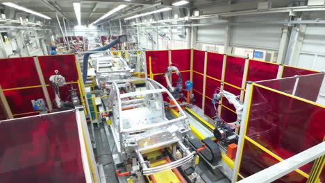 robot arm inspecting an automobile assembly line works in a factory that assembles lithium or sodium batteries used in cars or electric vehicle