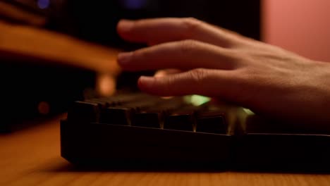 hands typing on a black keyboard on wooden custom desk