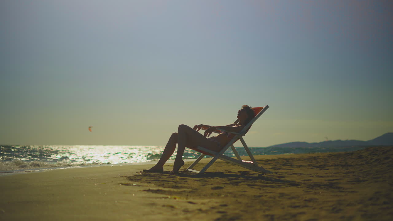 Woman Relaxing on Beach Chair at Sunset