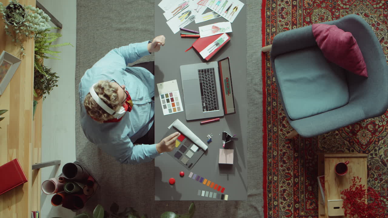 diseñador de moda escuchando música con auriculares en el trabajo