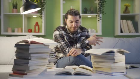 Tired-young-man-preparing-for-school-exams.