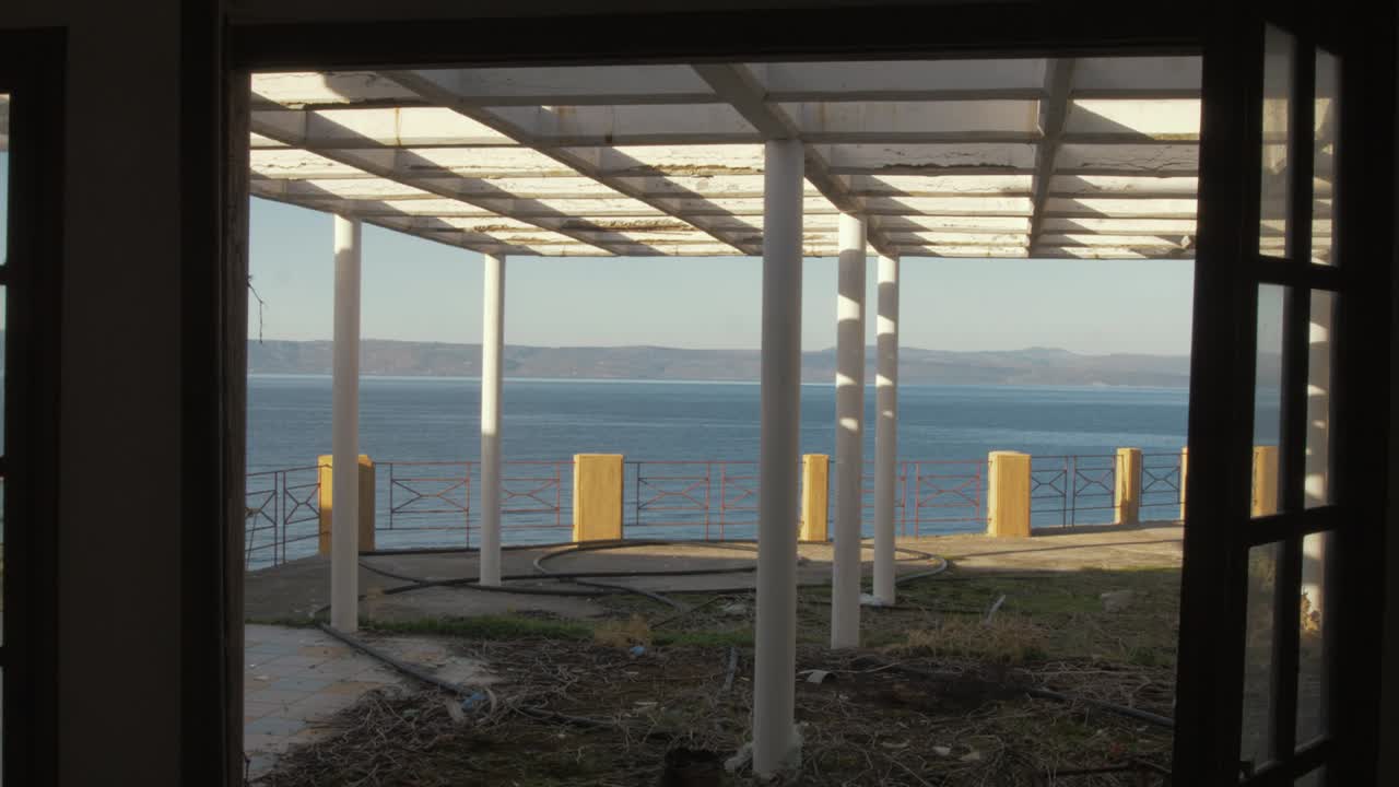 Derelict rundown building balcony view toward Turkey