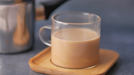 a cup of tea on a bamboo coaster