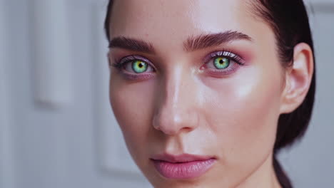 close-up portrait of a woman with vibrant green eyes and beautiful makeup