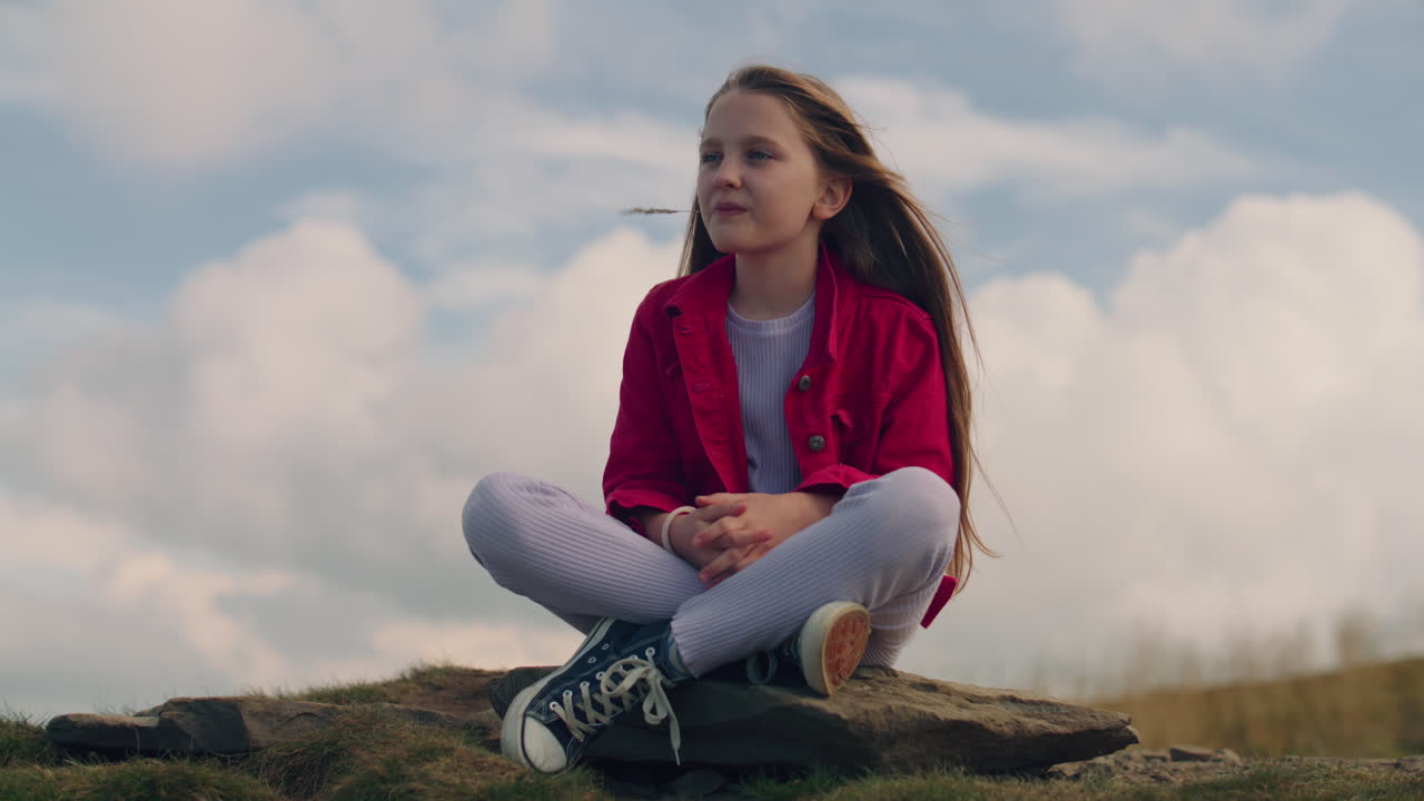 Portrait of a Young Girl Sitting on a Wickerwork in the Field Portrait of a Young Girl from the Countryside in a White Skirt and Shirt Sitting on a Wickerwork in the Field and Eating an Apple Lonely Girl Picnic in the Field