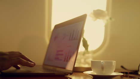 thoughtful man working computer in airplane closeup. stressed ceo considering