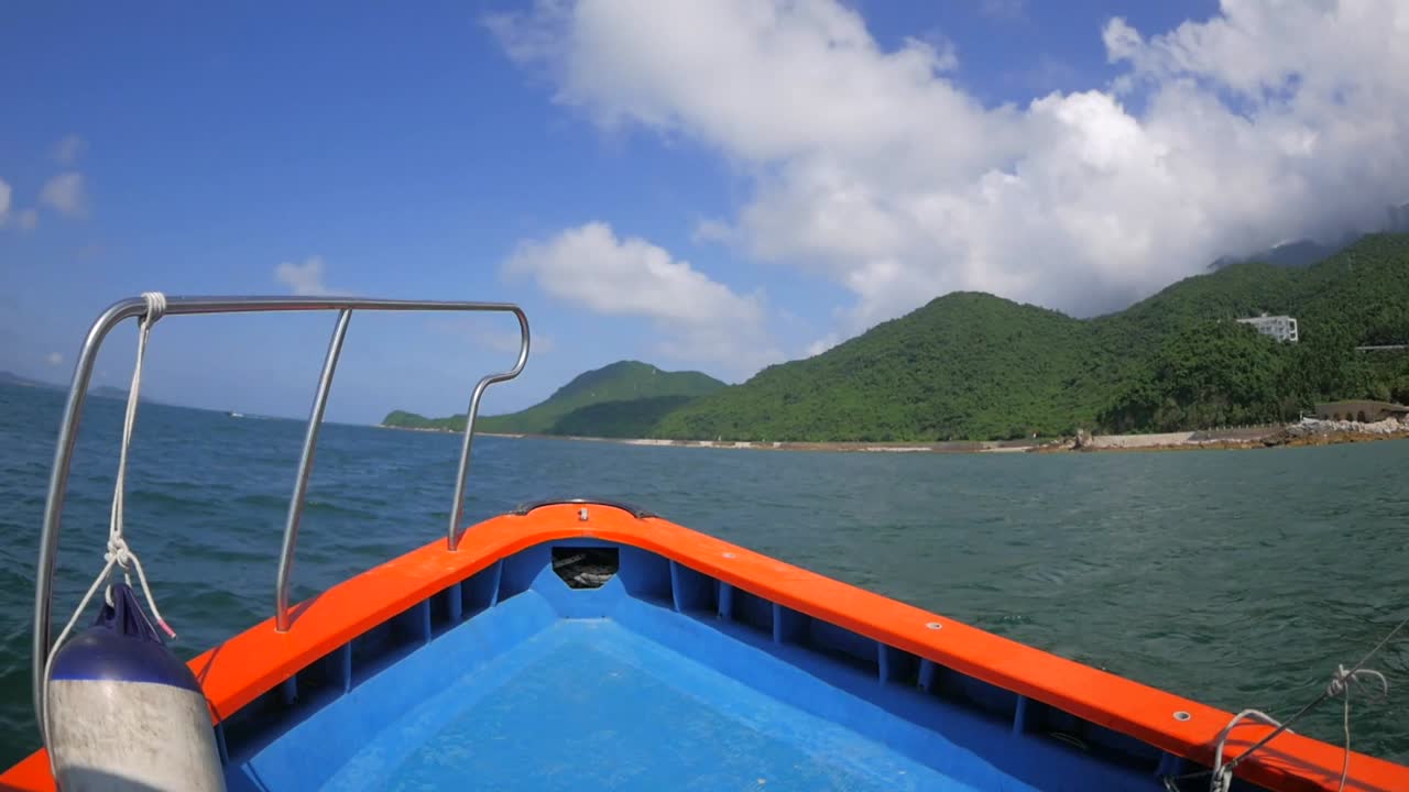 Cruising on a bumpy boat in a sea along the coast of breathtaking mountains