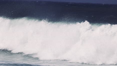 large waves crashing in rough pacific ocean waters