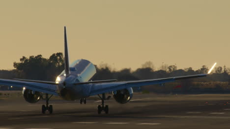 airplane landing at sunset